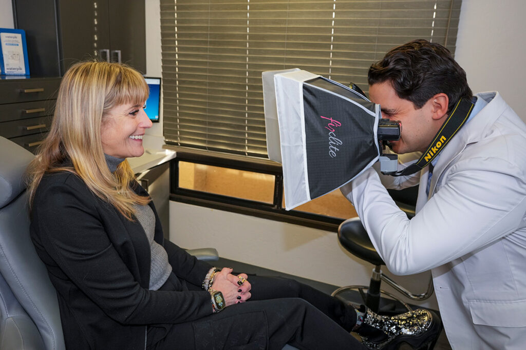 Dr. Bensoussan takes a photo of a patient's teeth
