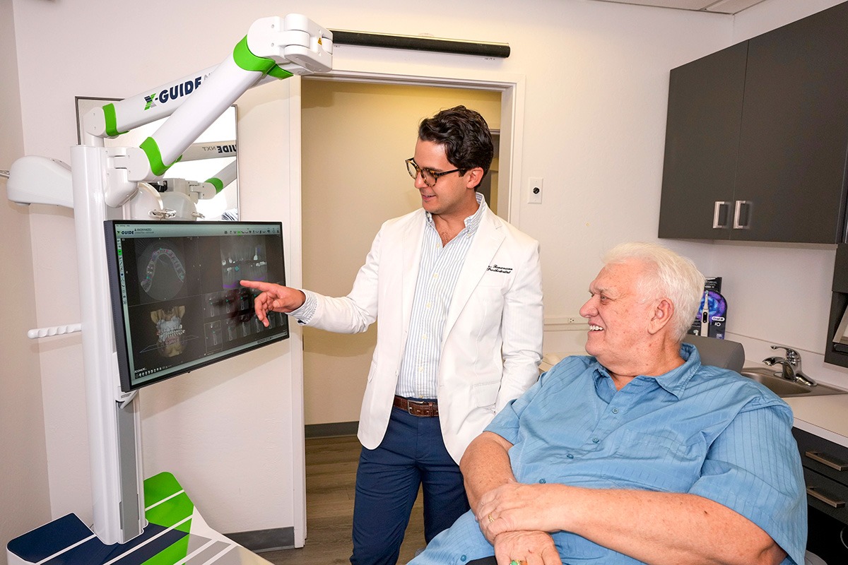 Showing patient how to avoid dental implant complications.